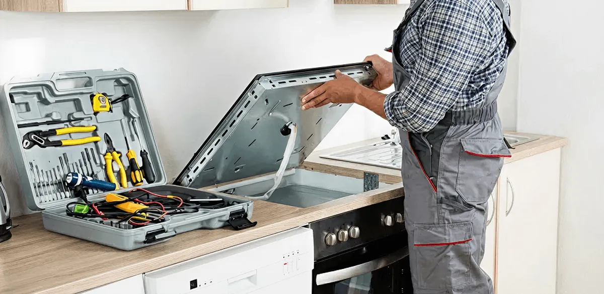 Handyman repairing a cooktop and checking wiring connections in Bradenton, FL