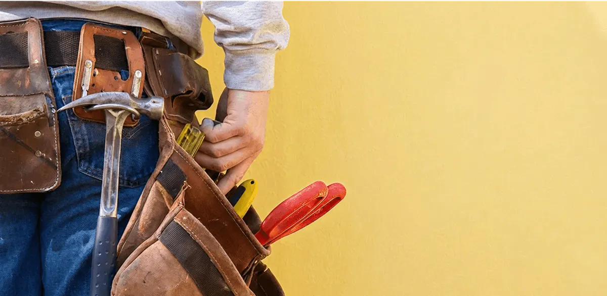 Handyman with tool belt ready for home repairs and maintenance in Bradenton, FL