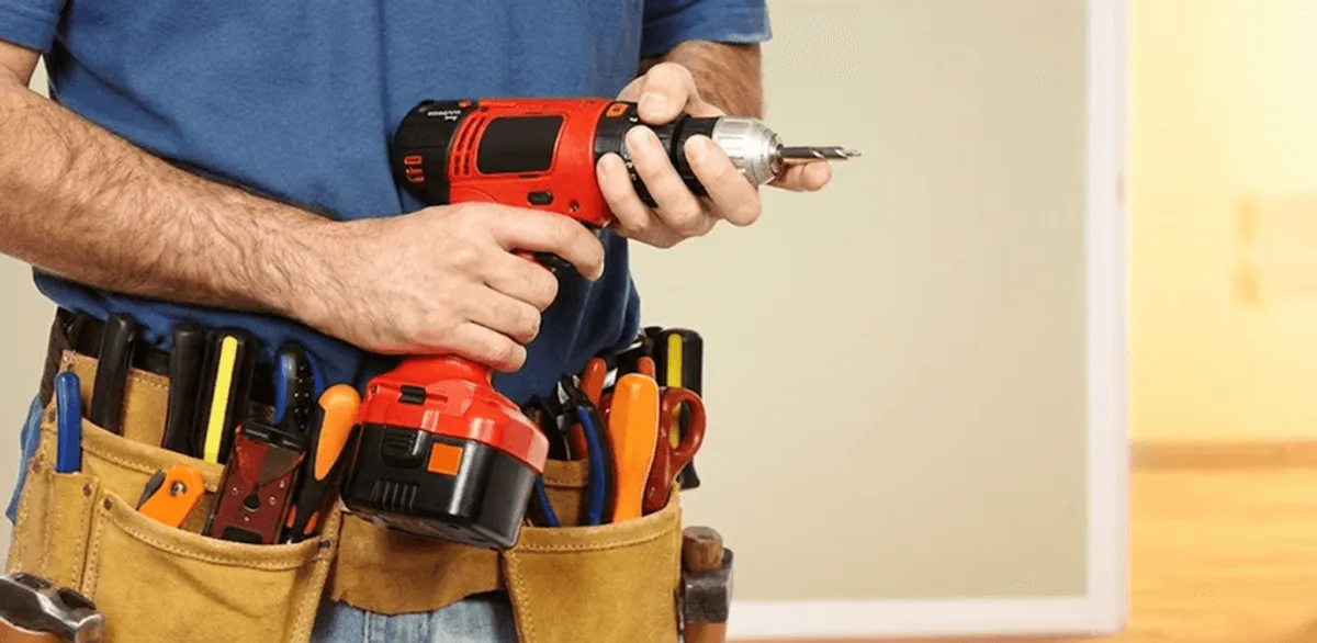 Handyman holding a power drill for home repairs and installations in Bradenton, FL